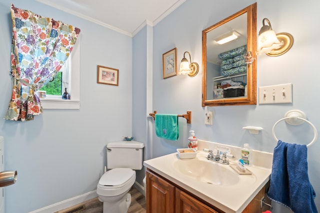 4 Otis St, Rockland, ME 04841 - half bath featuring ornamental molding, wood finished floors, vanity, toilet, and baseboards
