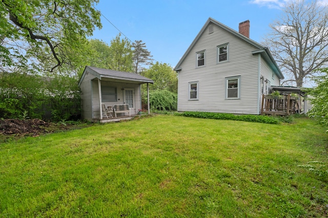 4 Otis St, Rockland, ME 04841 - back of house featuring a chimney, a lawn, and an outbuilding