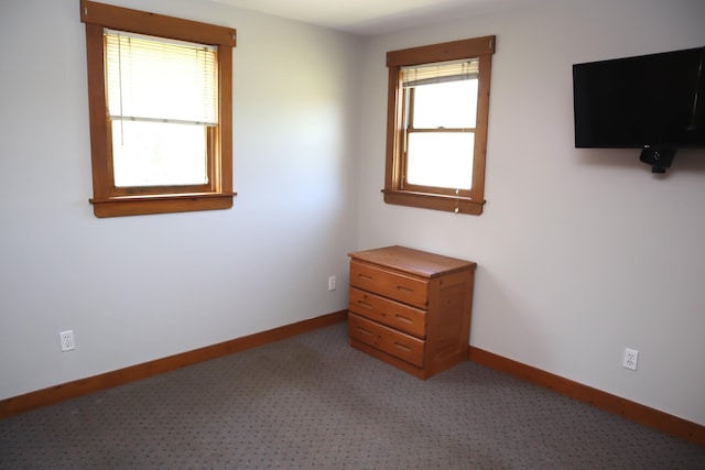 unfurnished bedroom featuring baseboards and light carpet