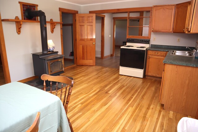 kitchen with white electric stove, open shelves, a sink, light wood-style flooring, and dark countertops