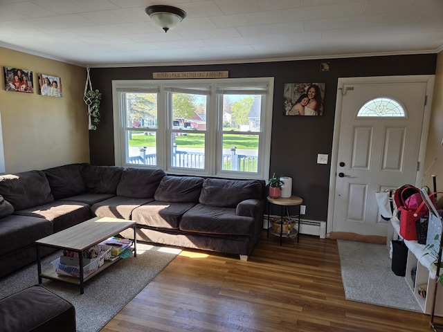 36 Lorraine Ave, Brewer, ME 04412 - living area featuring wood finished floors, ornamental molding, baseboard heating, and baseboards