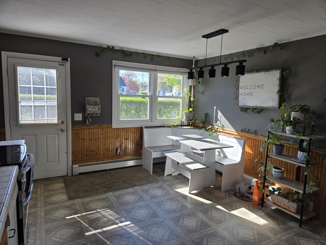 36 Lorraine Ave, Brewer, ME 04412 - dining space with baseboard heating, wainscoting, wooden walls, and tile patterned floors