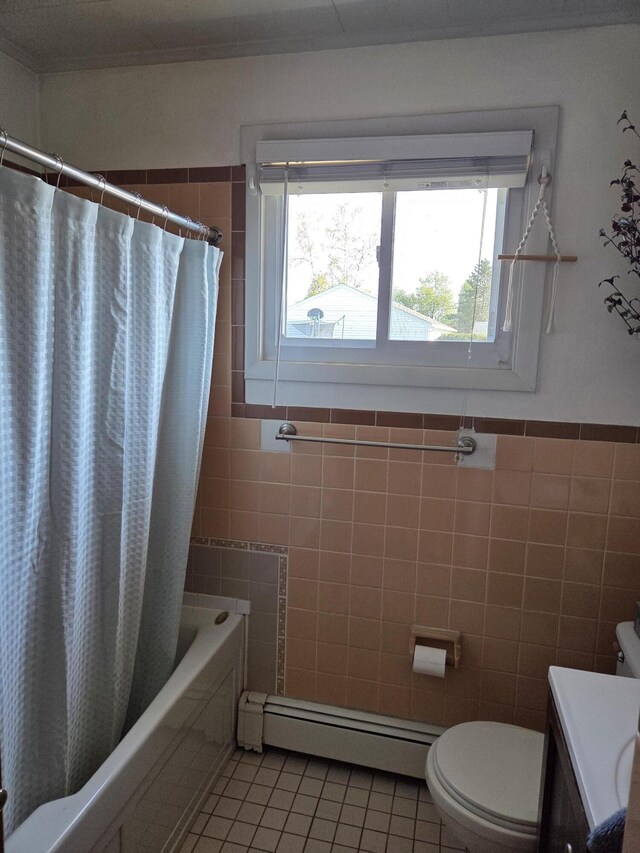 36 Lorraine Ave, Brewer, ME 04412 - bathroom featuring tile walls, a baseboard heating unit, healthy amount of natural light, tile patterned floors, and toilet