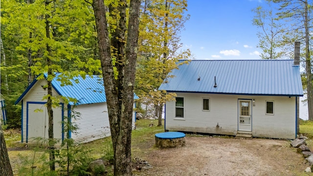 20 Lily Bay Ln, Parsonsfield, ME 04047 - rear view of property with metal roof, an outdoor structure, a trampoline, and entry steps
