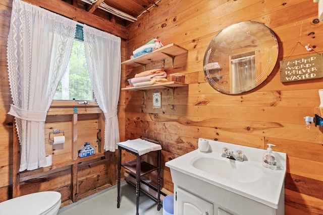 20 Lily Bay Ln, Parsonsfield, ME 04047 - bathroom with wooden walls, toilet, vanity, and finished concrete floors