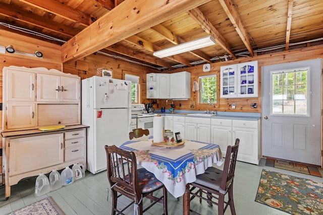 20 Lily Bay Ln, Parsonsfield, ME 04047 - kitchen with white appliances, wood walls, healthy amount of natural light, beam ceiling, and white cabinetry
