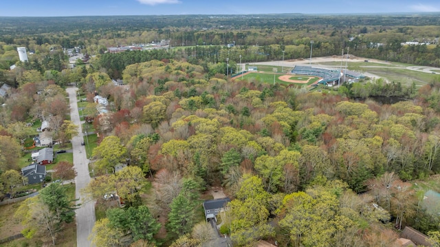 aerial view of property and surrounding area featuring a forest