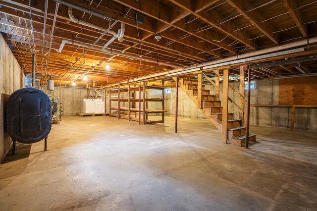 526 Range Rd, Dover-Foxcroft, ME 04426 - unfinished below grade area with oil tank, stairway, and independent washer and dryer