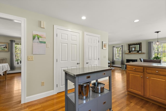 8 Silver Ridge Dr, York, ME 03909 - kitchen with a baseboard heating unit, brown cabinets, light wood-style flooring, baseboards, and recessed lighting