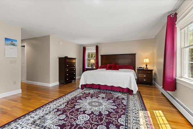 8 Silver Ridge Dr, York, ME 03909 - bedroom with a baseboard heating unit, wood finished floors, multiple windows, and baseboards