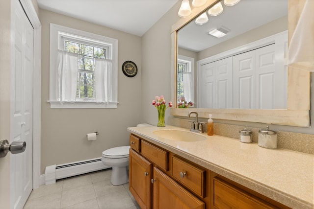 8 Silver Ridge Dr, York, ME 03909 - bathroom with a baseboard heating unit, a closet, vanity, toilet, and tile patterned floors