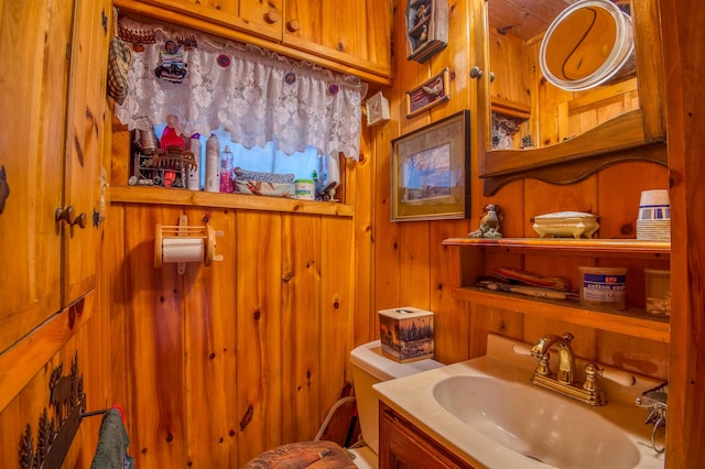 120 S Shore Dr, Rangeley Plt, ME 04970 - bathroom featuring toilet, wooden walls, and vanity
