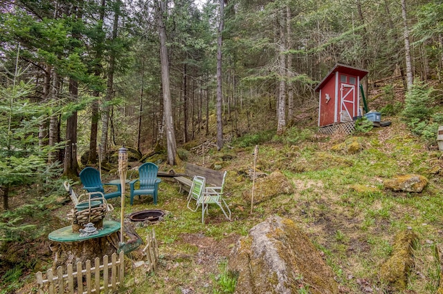 120 S Shore Dr, Rangeley Plt, ME 04970 - view of yard featuring an outdoor fire pit and a view of trees