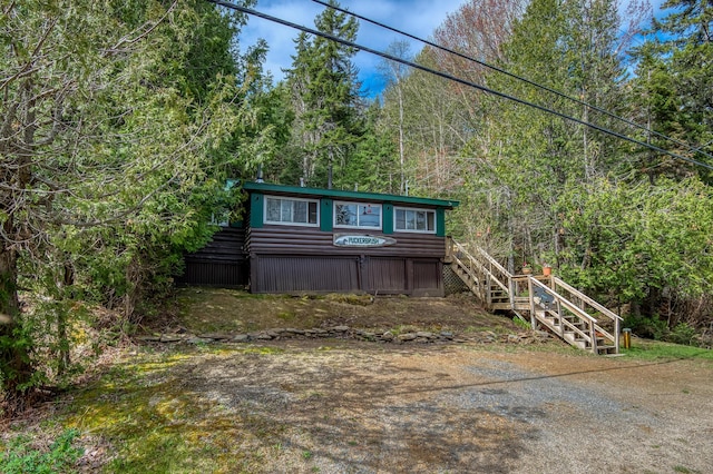 120 S Shore Dr, Rangeley Plt, ME 04970 - view of front of house featuring stairs and a forest view