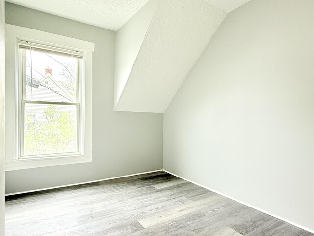 46 French St, Skowhegan, ME 04976 - bonus room with vaulted ceiling, wood finished floors, a textured ceiling, and baseboards