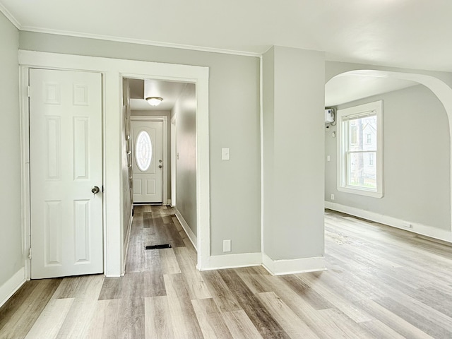 46 French St, Skowhegan, ME 04976 - foyer featuring arched walkways, light wood-type flooring, plenty of natural light, baseboards, and crown molding