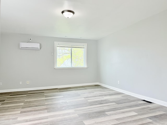 46 French St, Skowhegan, ME 04976 - unfurnished room with a wall mounted air conditioner, light wood-style flooring, and baseboards