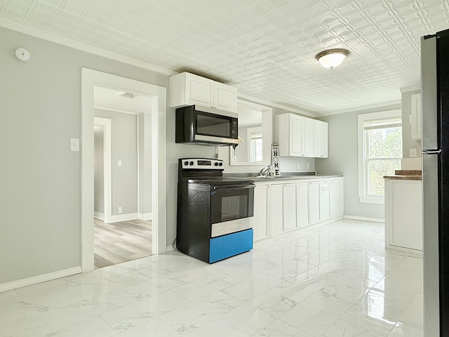 46 French St, Skowhegan, ME 04976 - kitchen featuring stainless steel appliances, ornamental molding, baseboards, white cabinetry, and an ornate ceiling