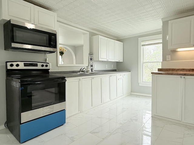 46 French St, Skowhegan, ME 04976 - kitchen with stainless steel appliances, a sink, light marble finish floors, an ornate ceiling, and baseboards