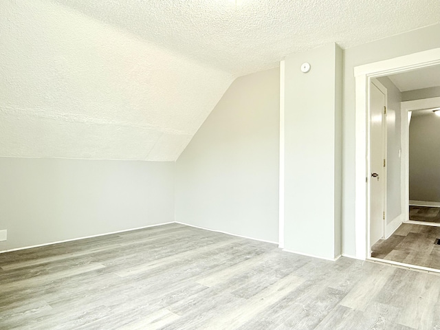 46 French St, Skowhegan, ME 04976 - additional living space featuring a textured ceiling, wood finished floors, and lofted ceiling