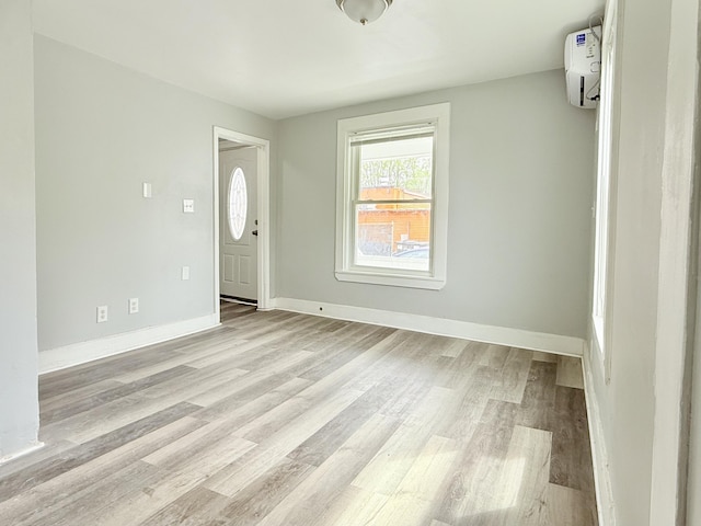 46 French St, Skowhegan, ME 04976 - foyer entrance with light wood-style flooring, baseboards, and a wall unit AC