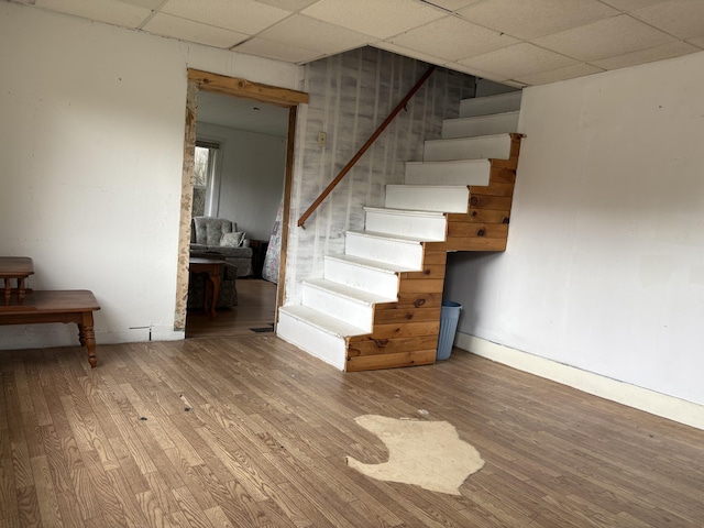 43 Berry Mills Rd, Carthage, ME 04224 - staircase featuring a paneled ceiling, wood finished floors, and baseboards
