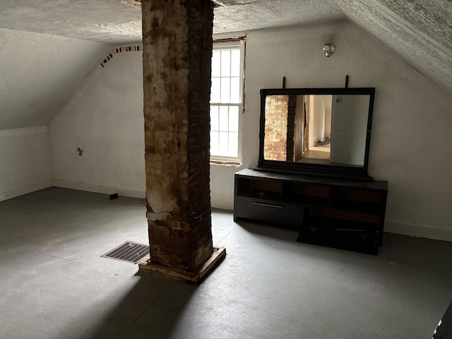 43 Berry Mills Rd, Carthage, ME 04224 - additional living space with lofted ceiling, concrete floors, a textured ceiling, and baseboards