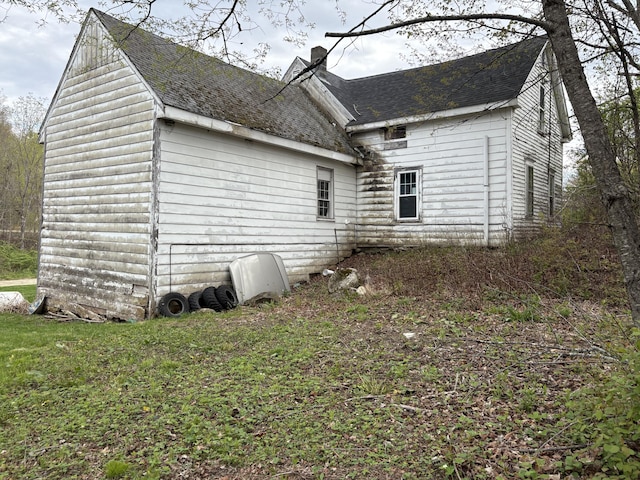 43 Berry Mills Rd, Carthage, ME 04224 - view of side of home with roof with shingles and a chimney