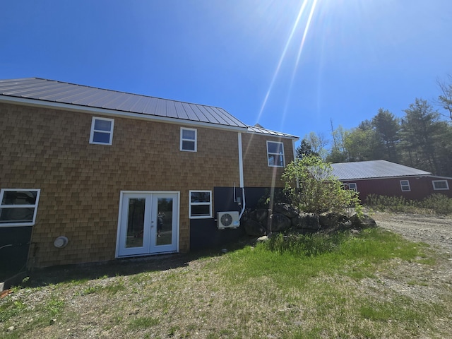 241 Baker Brook Rd, Bradley, ME 04411 - rear view of property with metal roof, ac unit, french doors, a lawn, and a standing seam roof