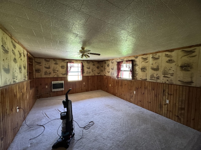7 Thomas Rd, Sangerville, ME 04479 - carpeted empty room featuring wainscoting, ceiling fan, wood walls, and heating unit