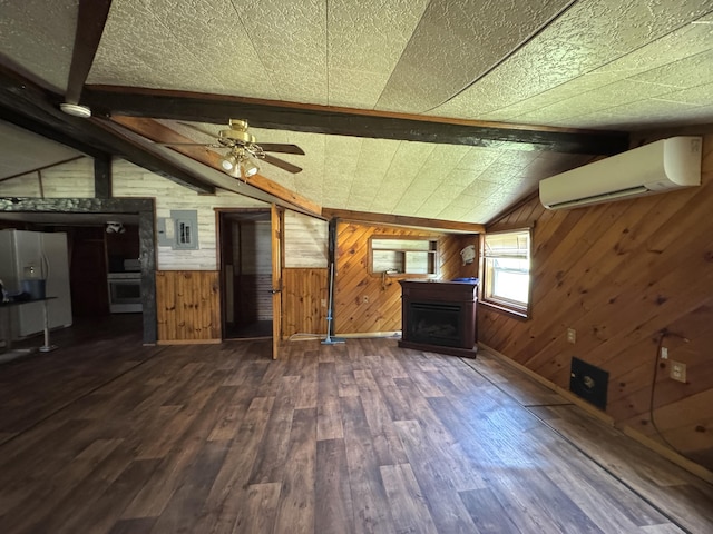 7 Thomas Rd, Sangerville, ME 04479 - unfurnished living room with an AC wall unit, wood walls, a fireplace, dark wood-style flooring, and a ceiling fan