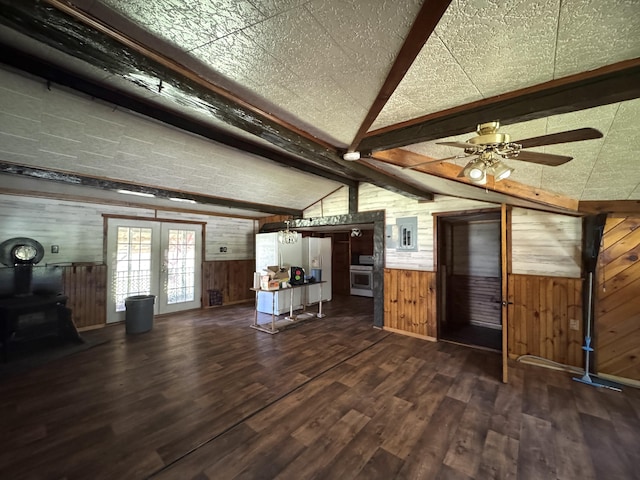 7 Thomas Rd, Sangerville, ME 04479 - living area with wood walls, dark wood-type flooring, a wood stove, french doors, and a ceiling fan
