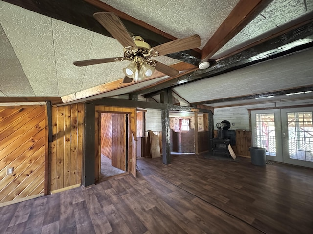 7 Thomas Rd, Sangerville, ME 04479 - unfurnished living room with a wood stove, wooden walls, wood finished floors, and ceiling fan