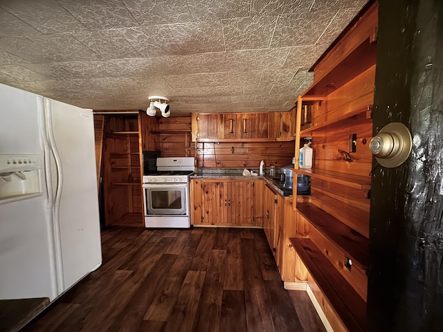 7 Thomas Rd, Sangerville, ME 04479 - kitchen with white appliances, open shelves, dark wood-style flooring, dark countertops, and brown cabinets