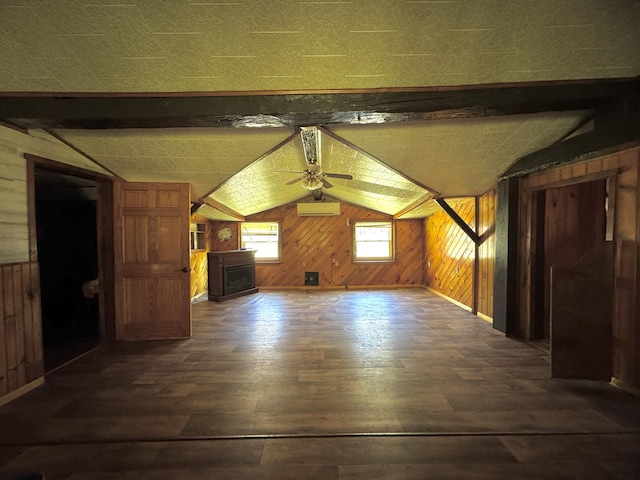 7 Thomas Rd, Sangerville, ME 04479 - bonus room with wood walls, dark wood-type flooring, vaulted ceiling, ceiling fan, and a wall mounted AC