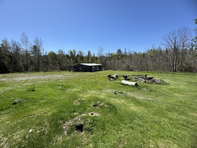 7 Thomas Rd, Sangerville, ME 04479 - view of grassy yard featuring a view of trees, a rural view, and a detached carport