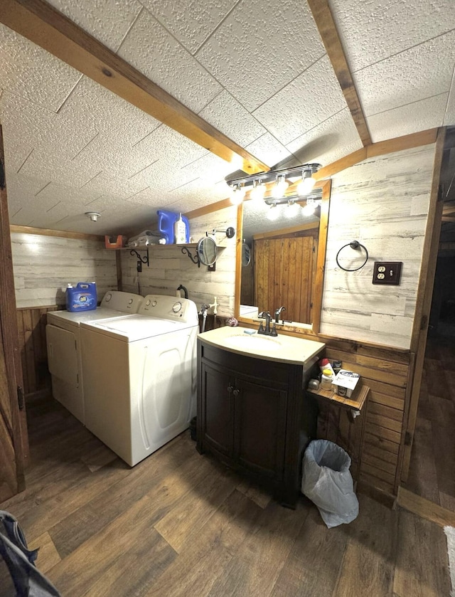 7 Thomas Rd, Sangerville, ME 04479 - clothes washing area with wood walls, washer and dryer, wood finished floors, and cabinet space