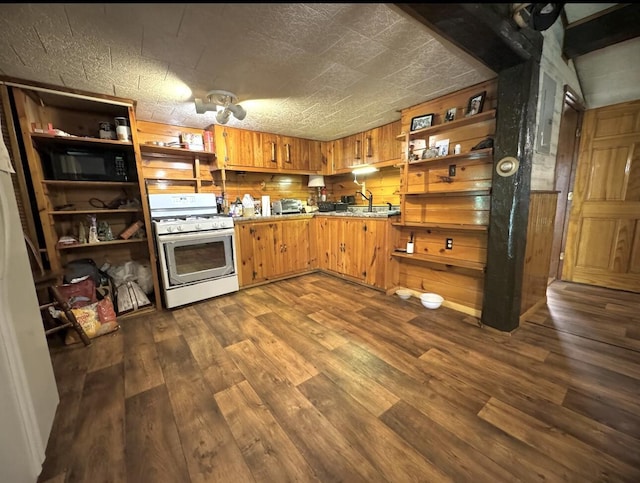 7 Thomas Rd, Sangerville, ME 04479 - kitchen featuring white range with gas stovetop, open shelves, dark wood-style flooring, black microwave, and brown cabinetry