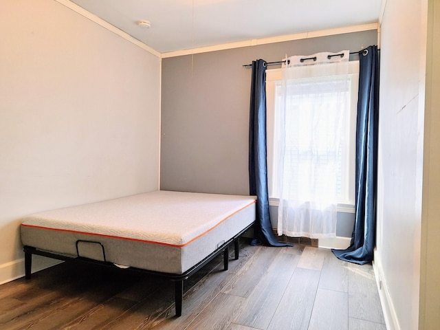bedroom with wood finished floors and baseboards