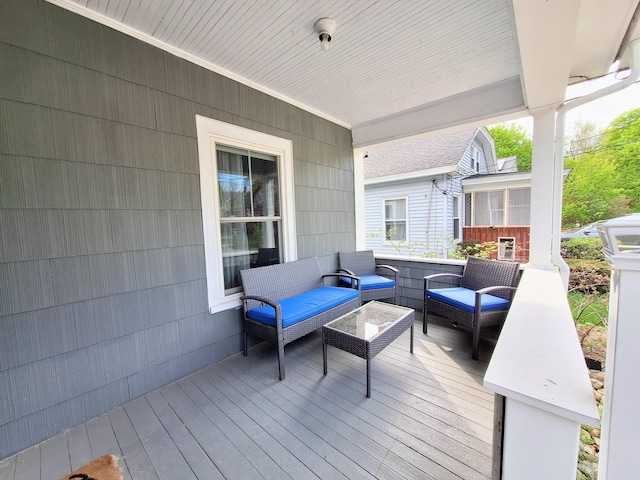 wooden terrace featuring outdoor lounge area and a sunroom
