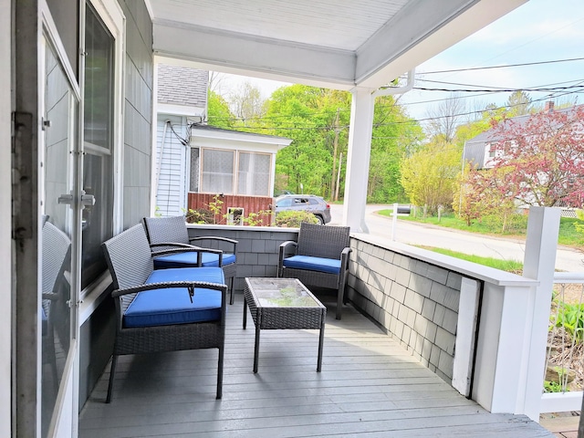 wooden terrace featuring an outdoor living space
