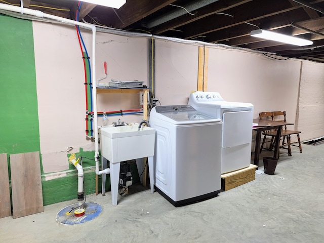 clothes washing area with separate washer and dryer