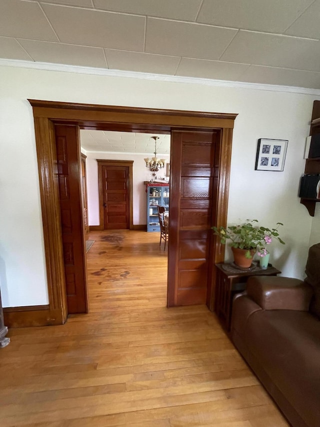27 Murray St, Bingham, ME 04920 - hall with crown molding, light wood finished floors, and a chandelier