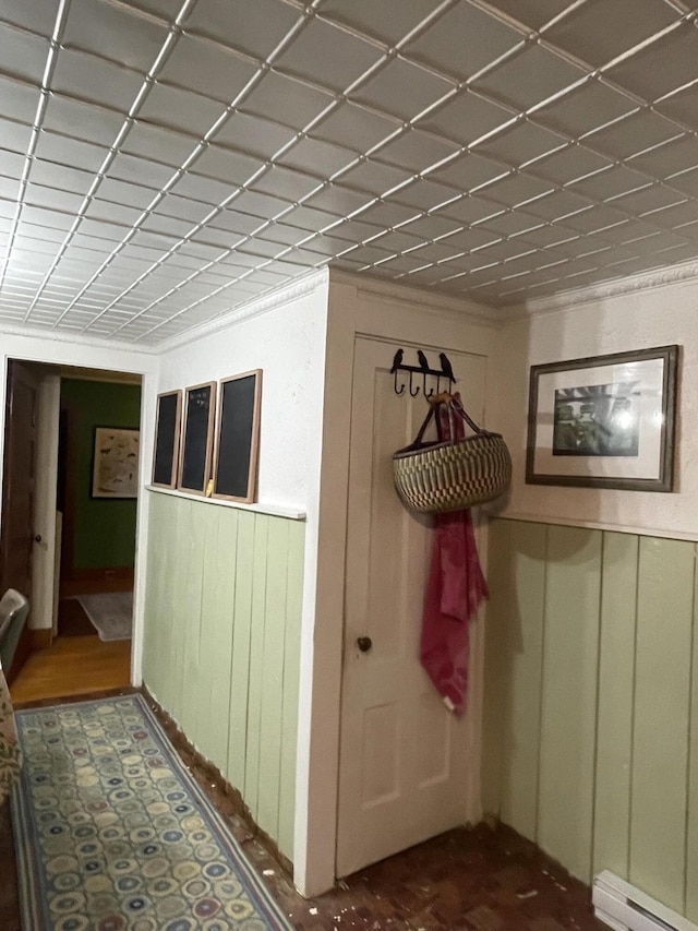 27 Murray St, Bingham, ME 04920 - corridor featuring a baseboard heating unit and a wainscoted wall