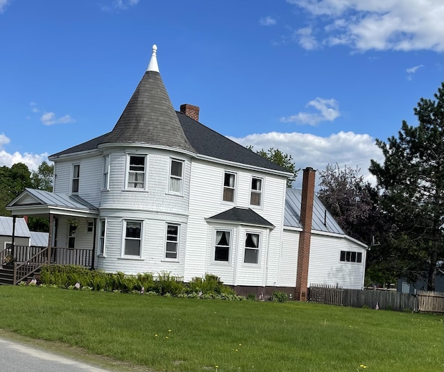 27 Murray St, Bingham, ME 04920 - view of home's exterior with a chimney, a porch, a shingled roof, and a standing seam roof