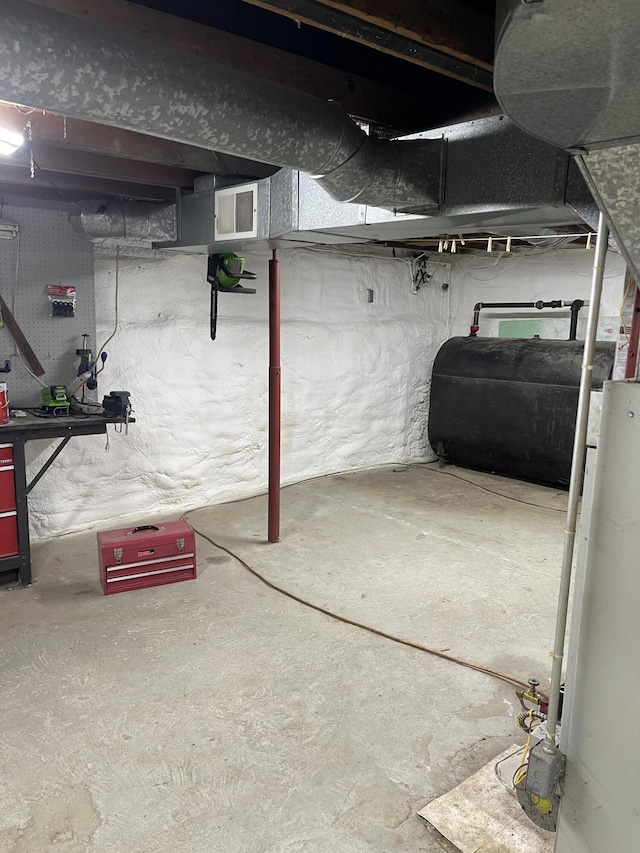 27 Murray St, Bingham, ME 04920 - unfinished below grade area with oil tank and water heater