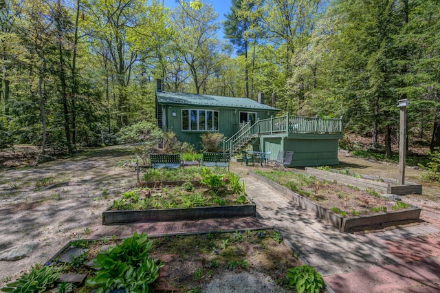 19 Pulpit Rock Rd, Raymond, ME 04071 - view of front of home with a vegetable garden, stairs, a deck, and metal roof