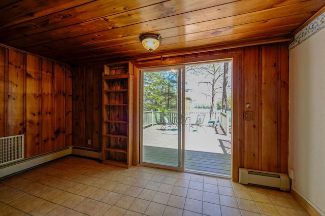 19 Pulpit Rock Rd, Raymond, ME 04071 - entryway featuring a baseboard radiator, wood ceiling, light tile patterned floors, and wooden walls