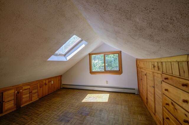19 Pulpit Rock Rd, Raymond, ME 04071 - additional living space with a baseboard radiator, a skylight, a textured ceiling, and lofted ceiling