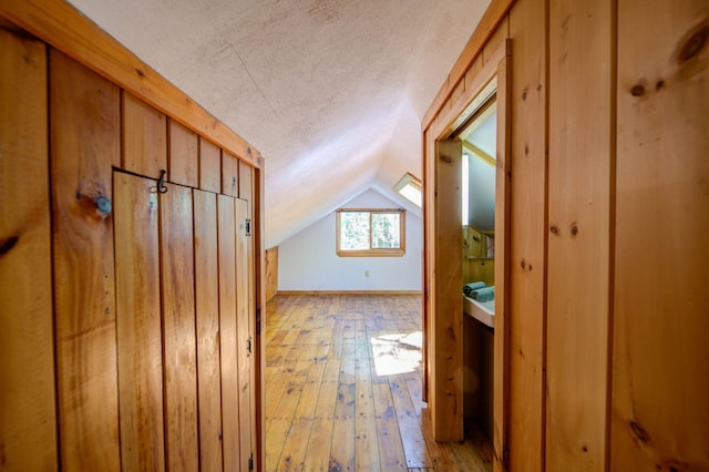 19 Pulpit Rock Rd, Raymond, ME 04071 - hallway with a textured ceiling, vaulted ceiling, and light wood-style floors